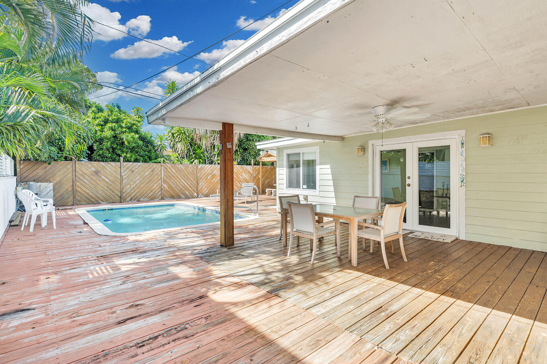 1014 17th Terrace Key West, FL 33040 - Photo 9 of 32 a view of a patio with table and chairs with wooden floor and fence