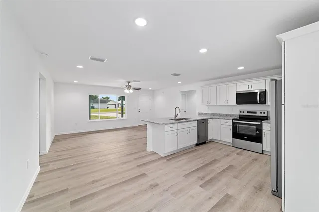 a view of kitchen with sink and window