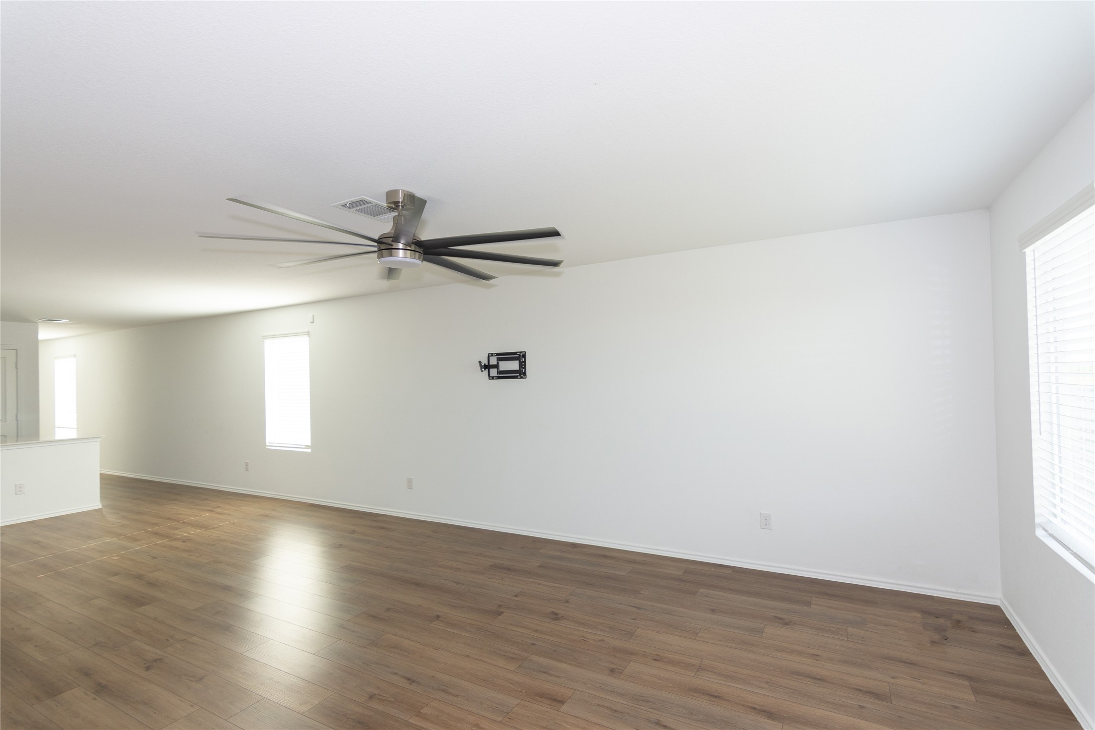544 Rancho Del Cielo Loop Jarrell, TX 76537 - Photo 11 of 39 Spare room featuring a ceiling fan and dark wood finished floors