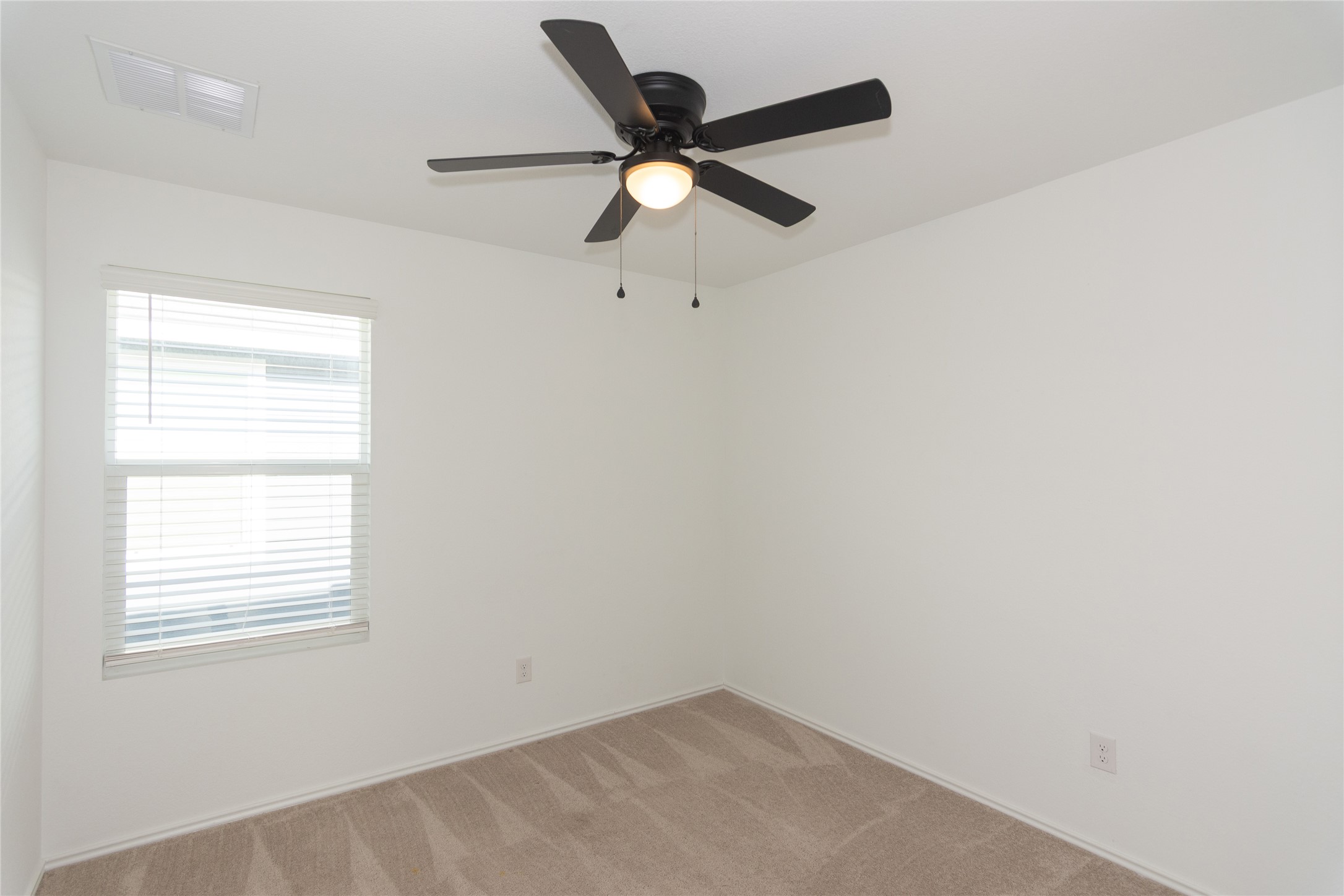 544 Rancho Del Cielo Loop Jarrell, TX 76537 - Photo 19 of 39 Empty room with light colored carpet and a ceiling fan