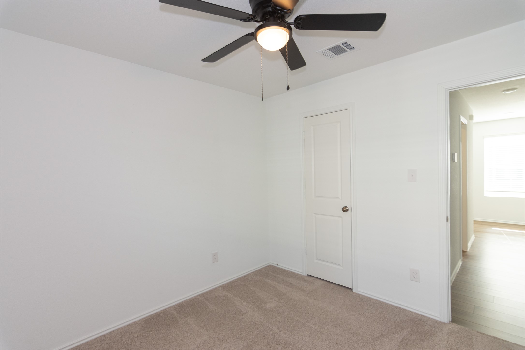 544 Rancho Del Cielo Loop Jarrell, TX 76537 - Photo 20 of 39 Unfurnished bedroom featuring light colored carpet and a ceiling fan