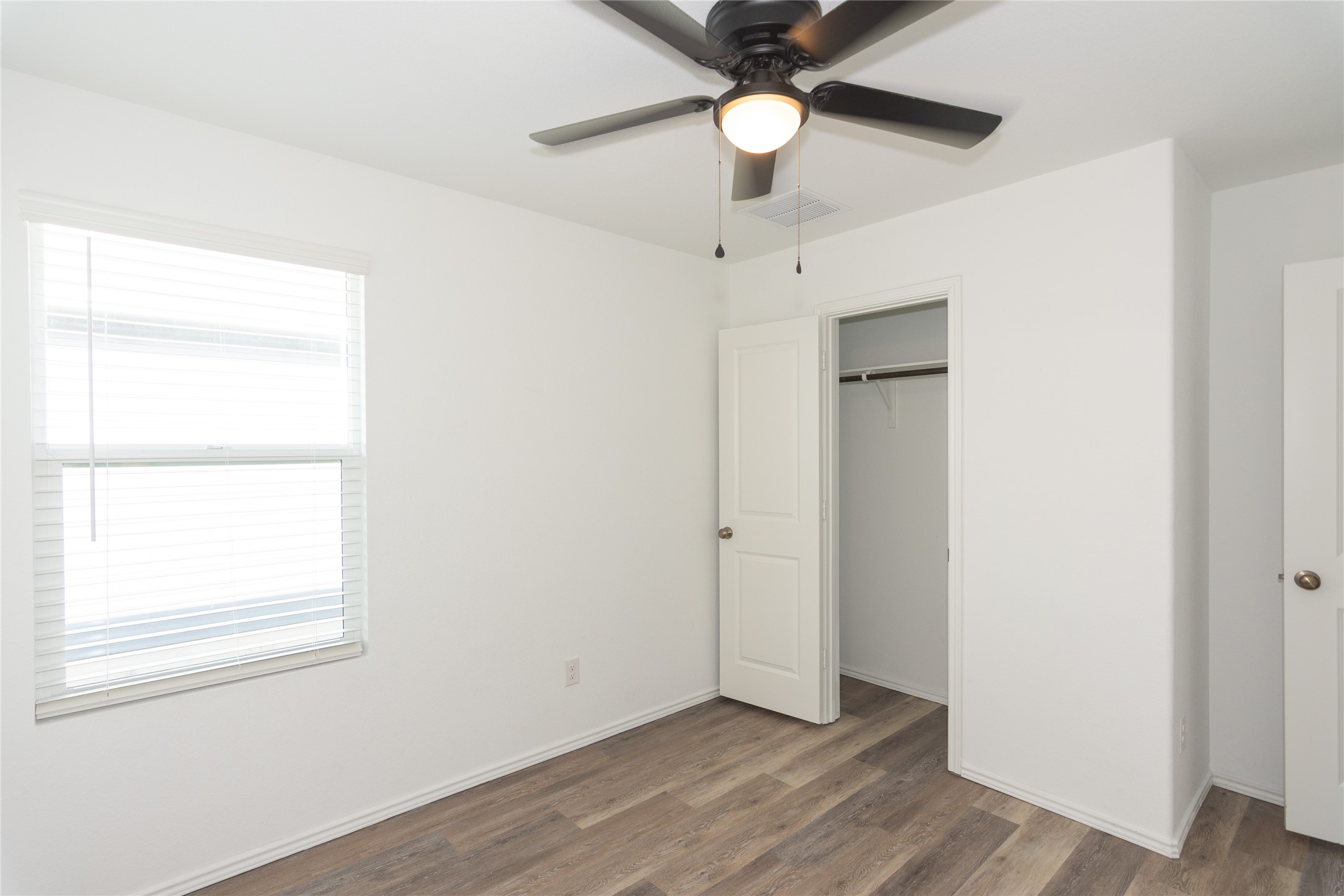 544 Rancho Del Cielo Loop Jarrell, TX 76537 - Photo 22 of 39 Unfurnished bedroom featuring dark wood finished floors, a closet, and a ceiling fan