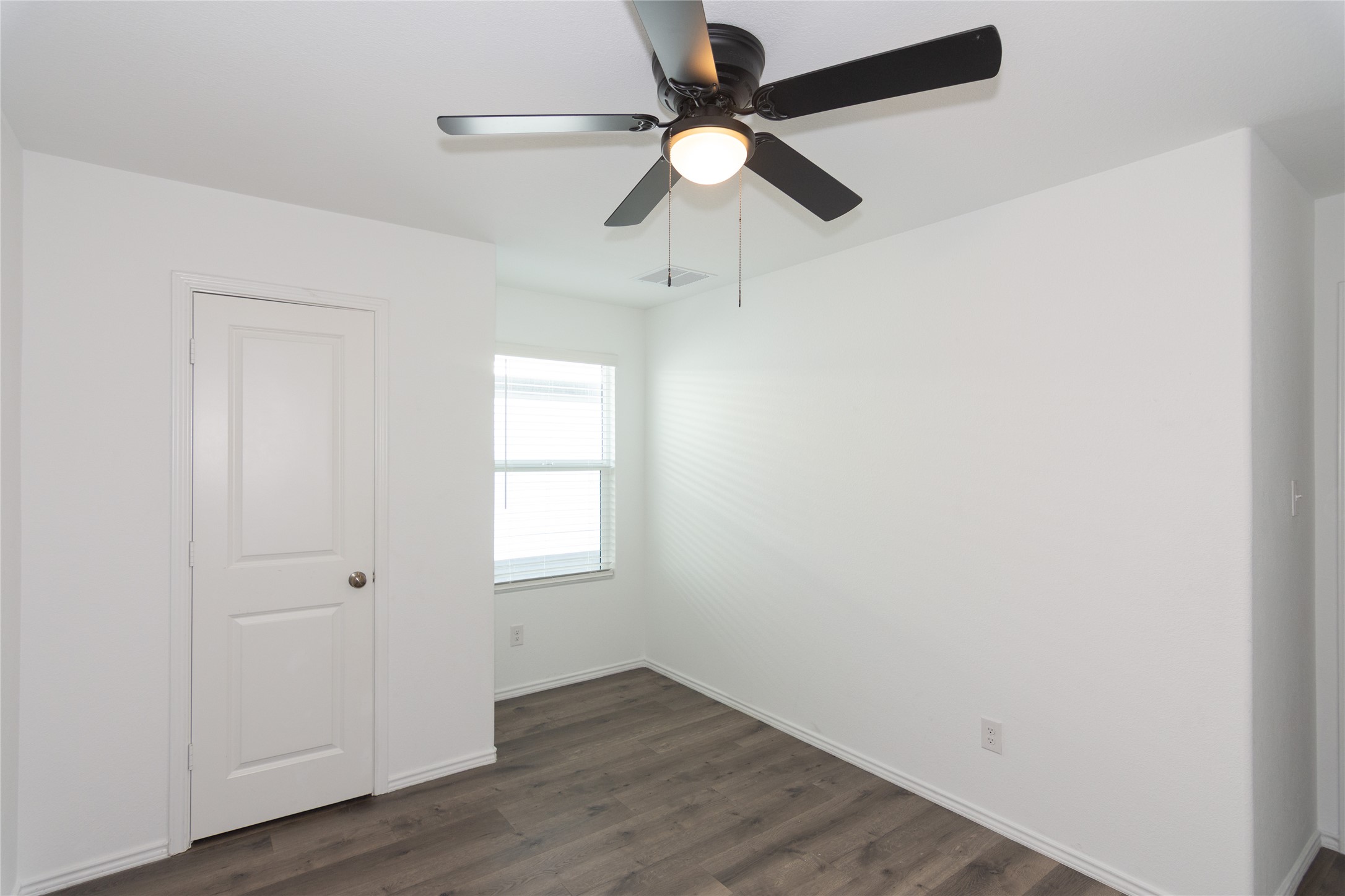 544 Rancho Del Cielo Loop Jarrell, TX 76537 - Photo 25 of 39 Unfurnished bedroom featuring dark wood-style flooring and ceiling fan