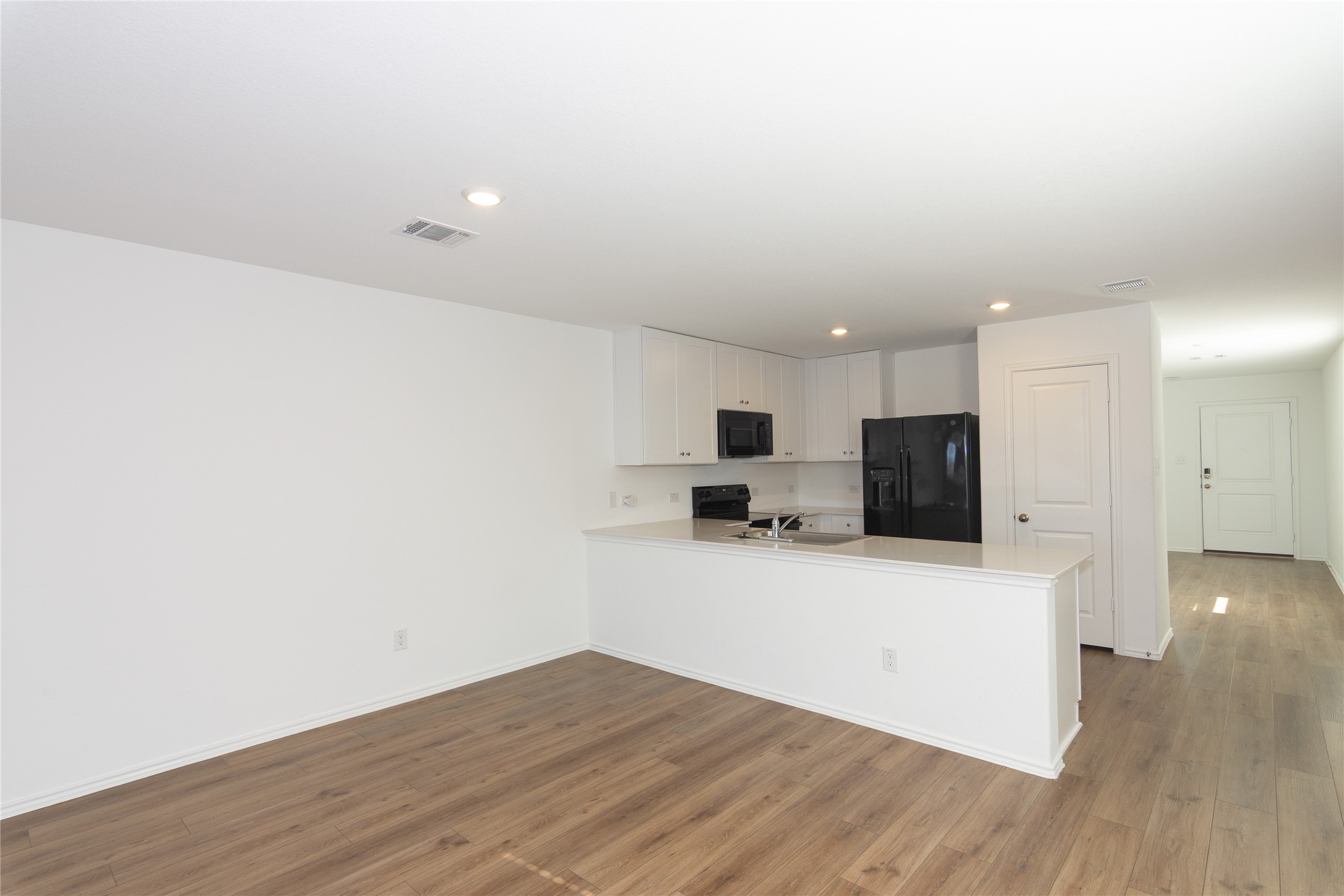 544 Rancho Del Cielo Loop Jarrell, TX 76537 - Photo 8 of 39 Unfurnished living room with dark wood finished floors and recessed lighting