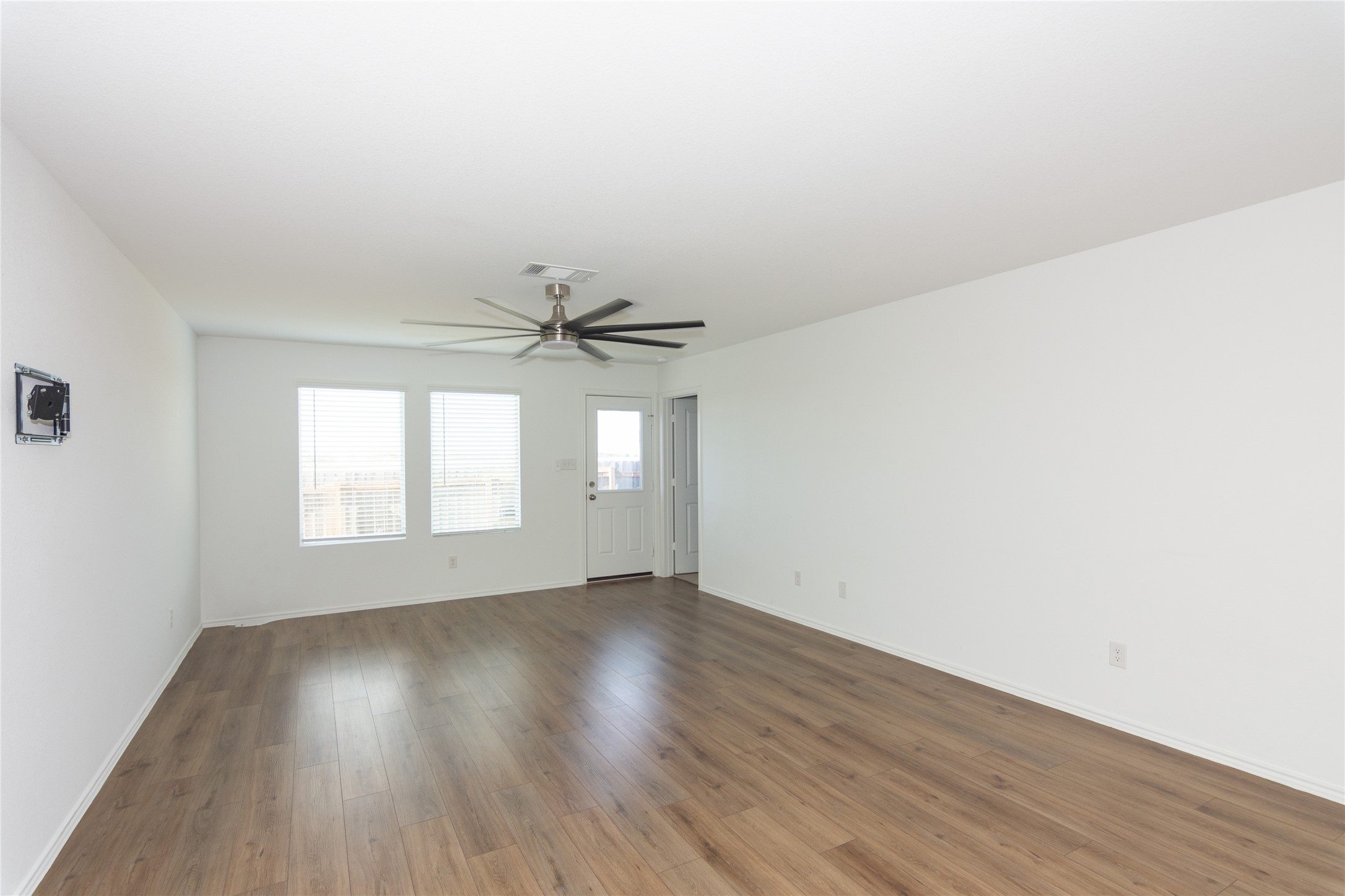 544 Rancho Del Cielo Loop Jarrell, TX 76537 - Photo 10 of 39 Unfurnished living room with a ceiling fan and dark wood finished floors