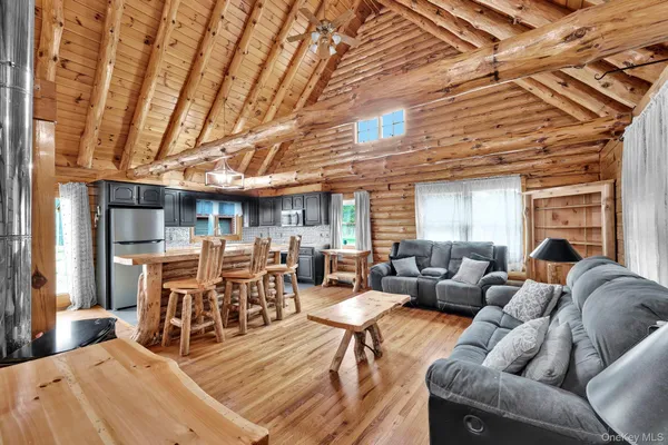a living room with furniture a fireplace and wooden floors