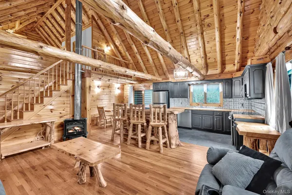 a dining room with wooden floor furniture and a chandelier