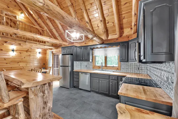 a kitchen with kitchen island granite countertop lots of counter top space and stainless steel appliances