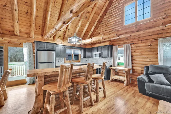 a view of a patio with dining table and chairs with wooden floor and fence