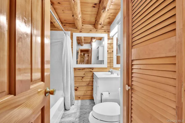 a bathroom with a toilet a sink and shower