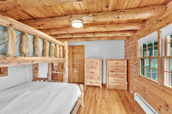 a view of a bedroom with furniture and windows