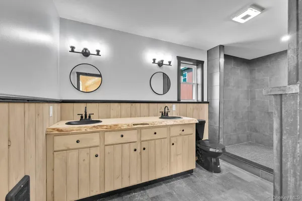 a bathroom with a double vanity sink and a mirror