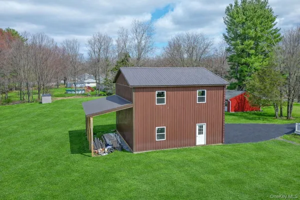 a aerial view of a house with a yard and trees