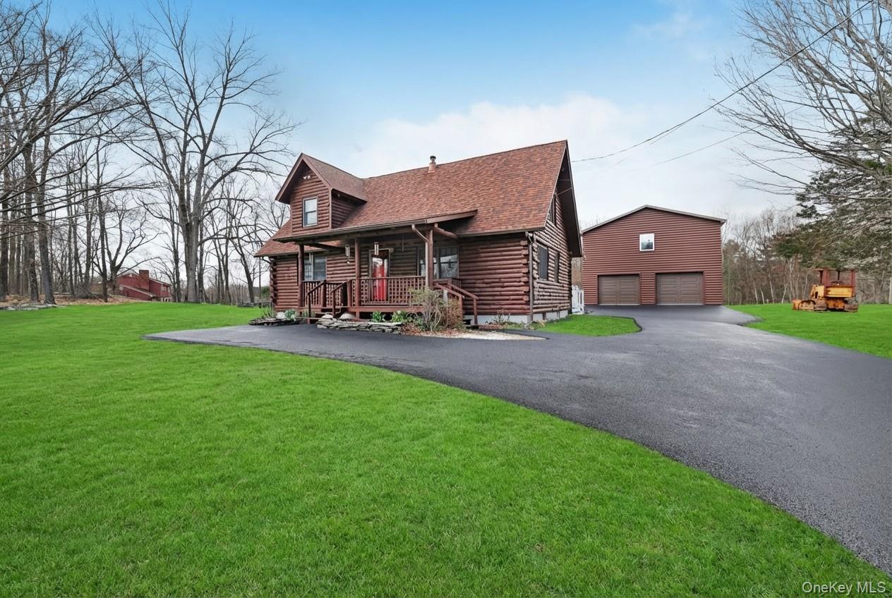 481 Dosen Road Middletown, NY 10940 - Photo 4 of 42 a front view of a house with a yard and garage