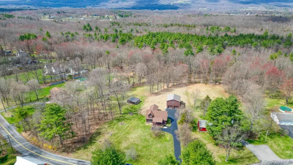 an aerial view of a house with a yard