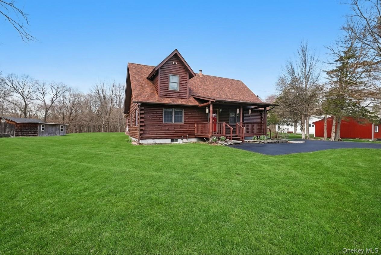481 Dosen Road Middletown, NY 10940 - Photo 5 of 42 a front view of a house with a yard table and chairs