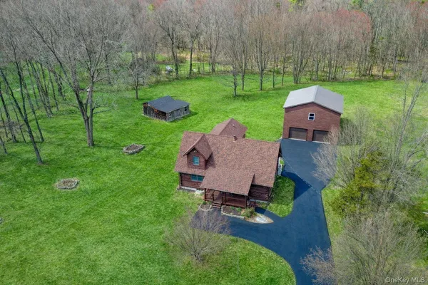 an aerial view of a house with garden space and trees