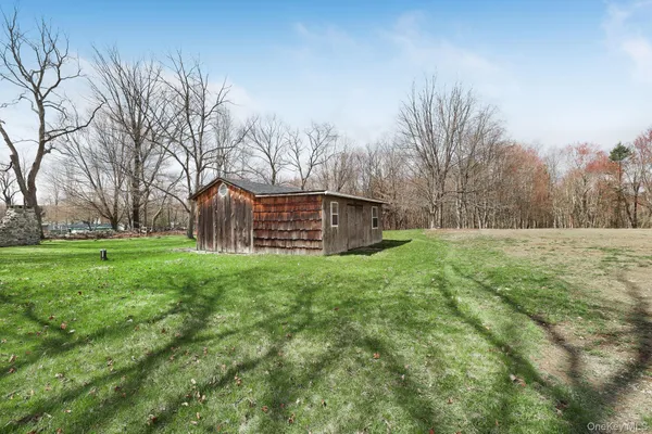 a view of a backyard with large trees