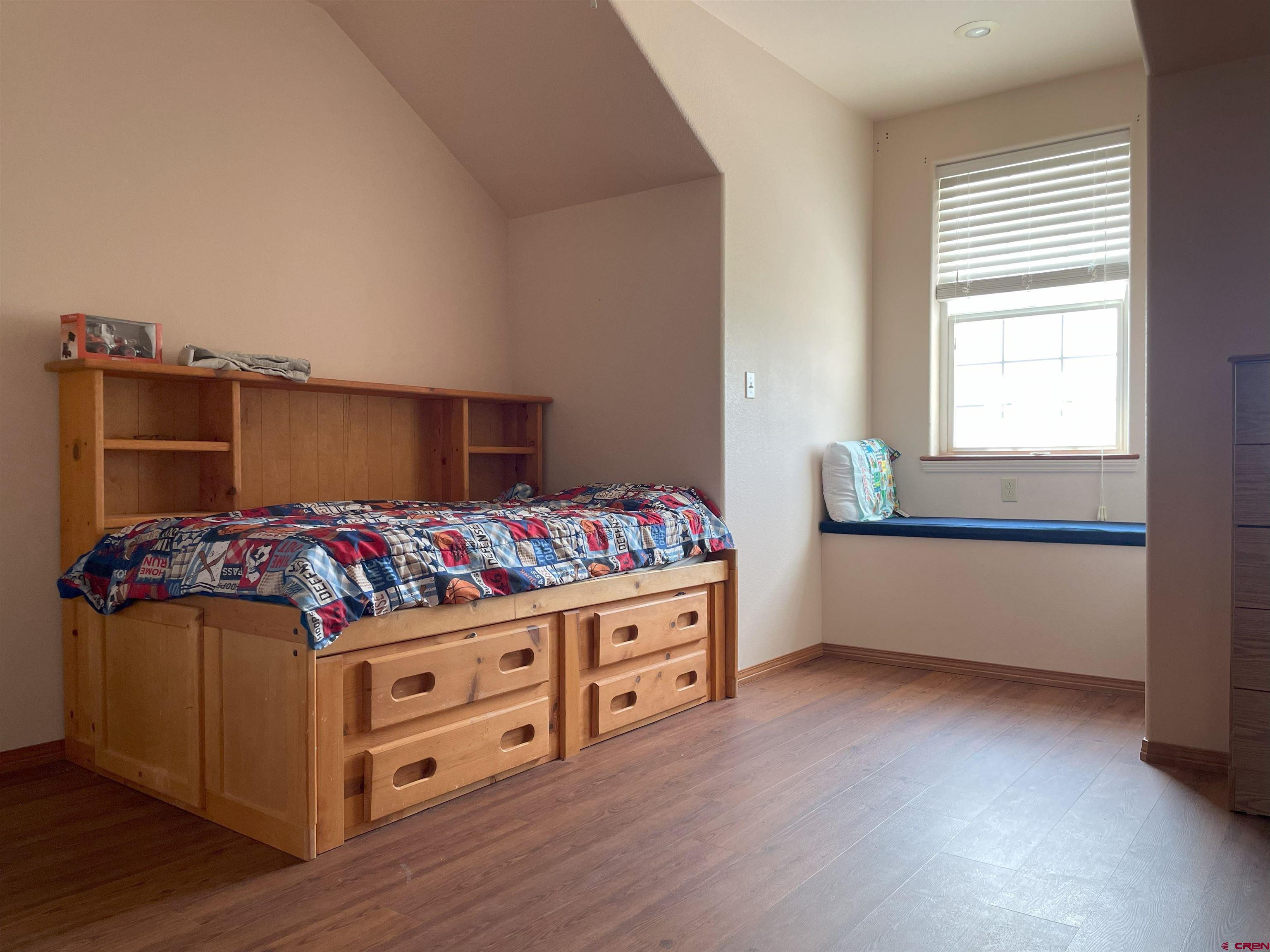 a kitchen with stainless steel appliances kitchen island wooden floors and wooden cabinets