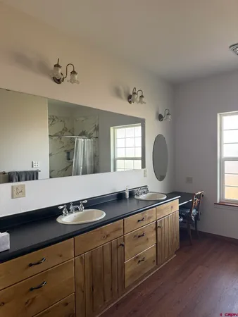 a bathroom with a double vanity sink and a mirror