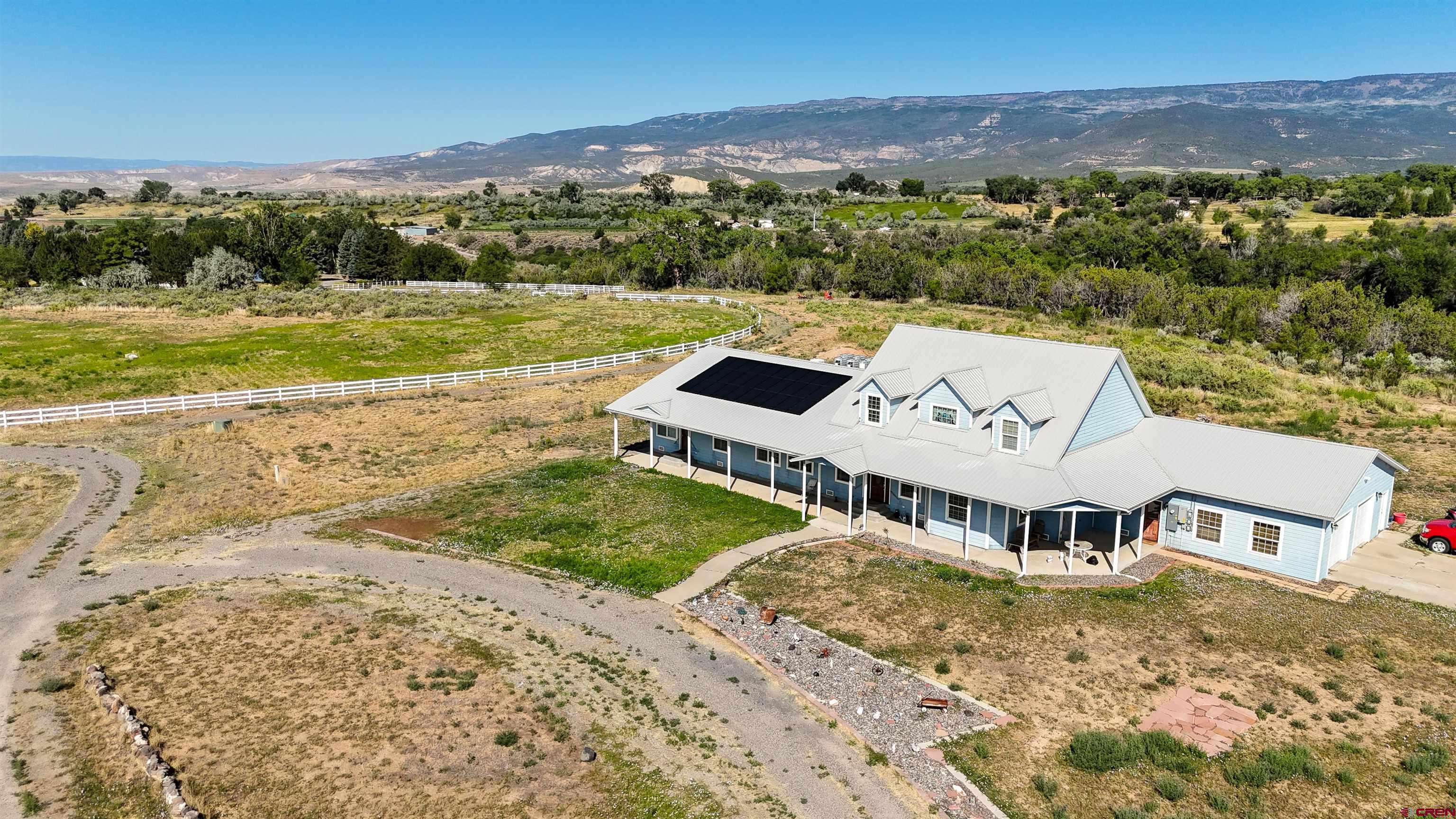 1552 Southwest Painted Fork Road Cedaredge, CO 81413 - Photo 2 of 45 an aerial view of a house with a yard