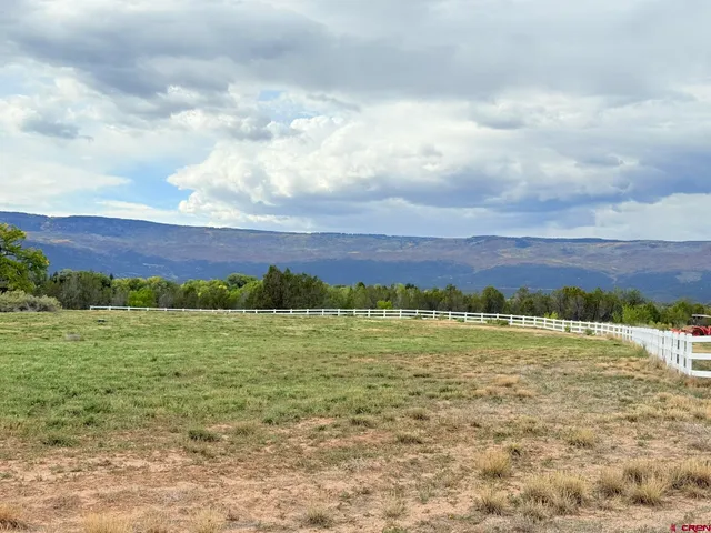 a view of a barn in the middle of a field