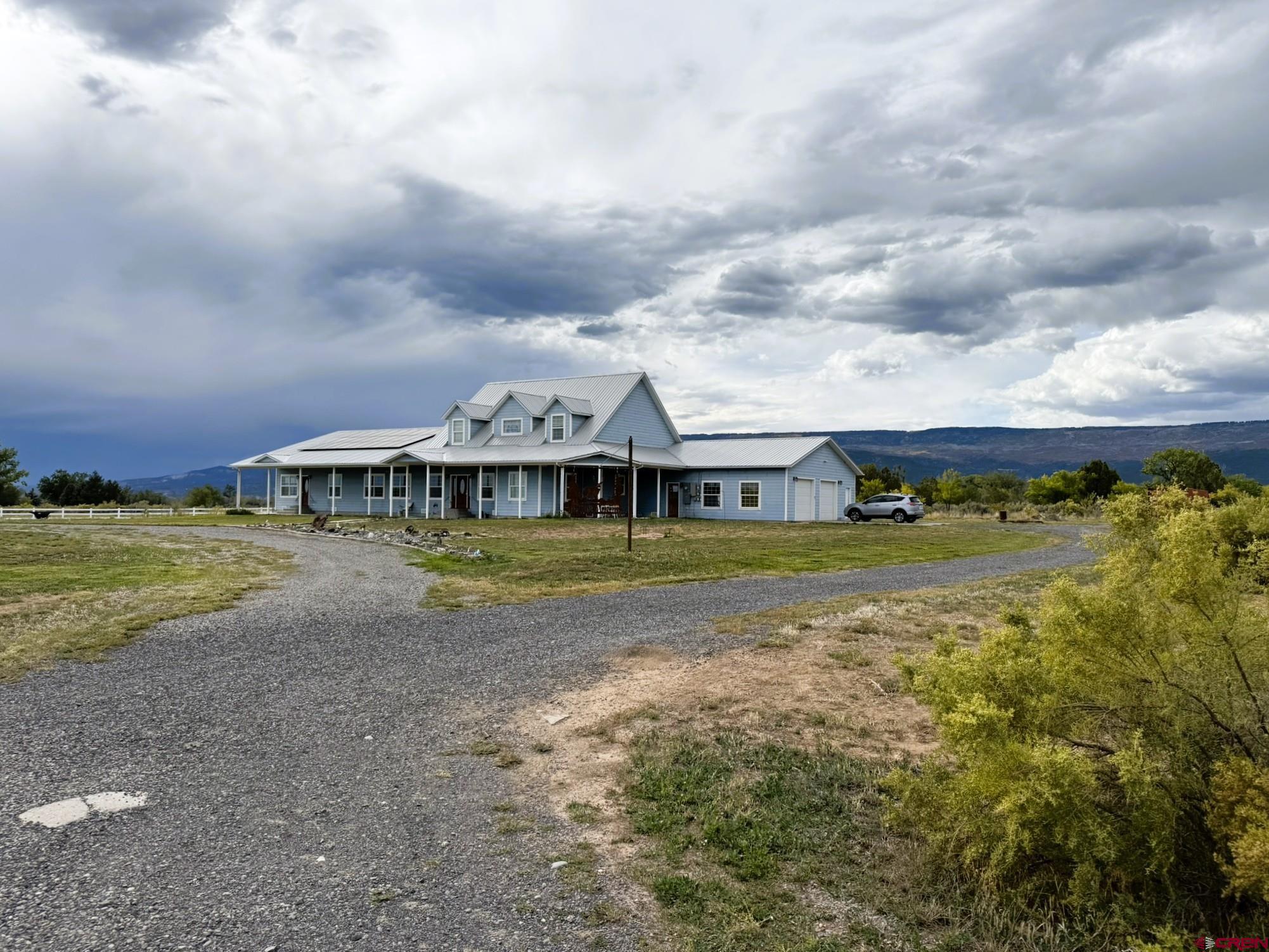 1552 Southwest Painted Fork Road Cedaredge, CO 81413 - Photo 44 of 45 a view of a house with a big yard and sitting area