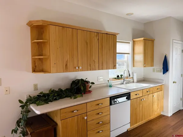 a kitchen with sink a stove and cabinets