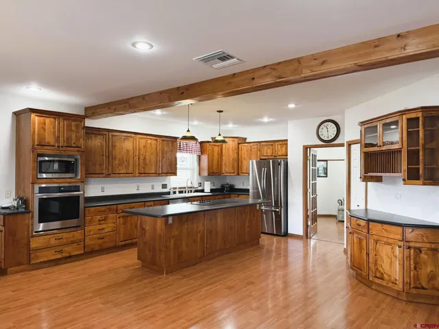 a view of a living room with kitchen