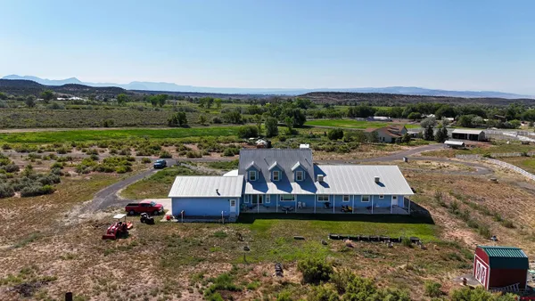 an aerial view of a residential houses and outdoor space