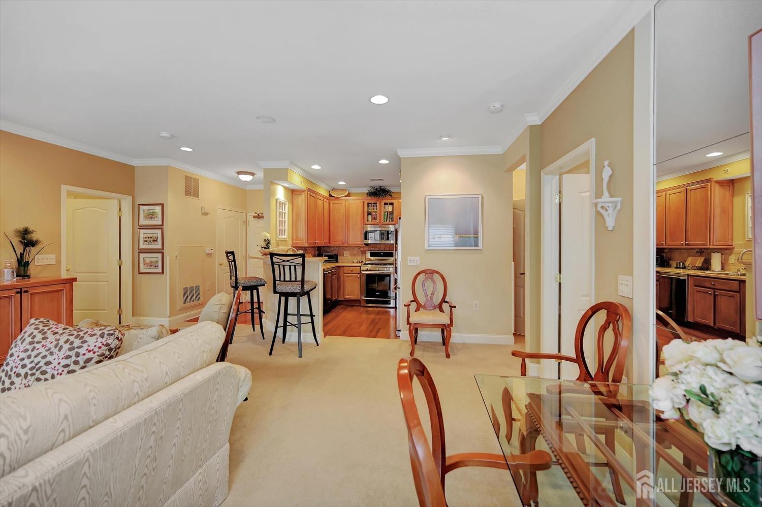 1322 Falston Circle Old Bridge, NJ 08857 - Photo 12 of 38 a living room with furniture a chandelier and kitchen view