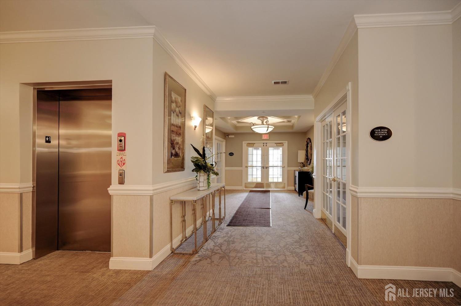 1322 Falston Circle Old Bridge, NJ 08857 - Photo 37 of 38 a view of a hallway to a livingroom with wooden floor and windows