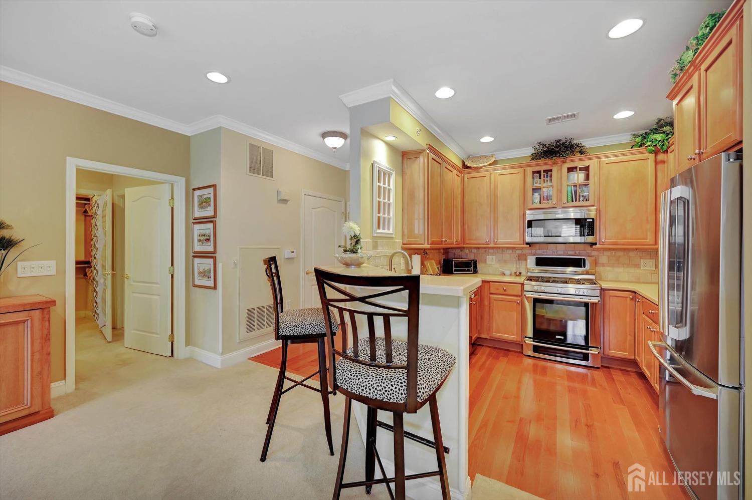 1322 Falston Circle Old Bridge, NJ 08857 - Photo 5 of 38 a kitchen with kitchen island a large counter top space appliances and cabinets