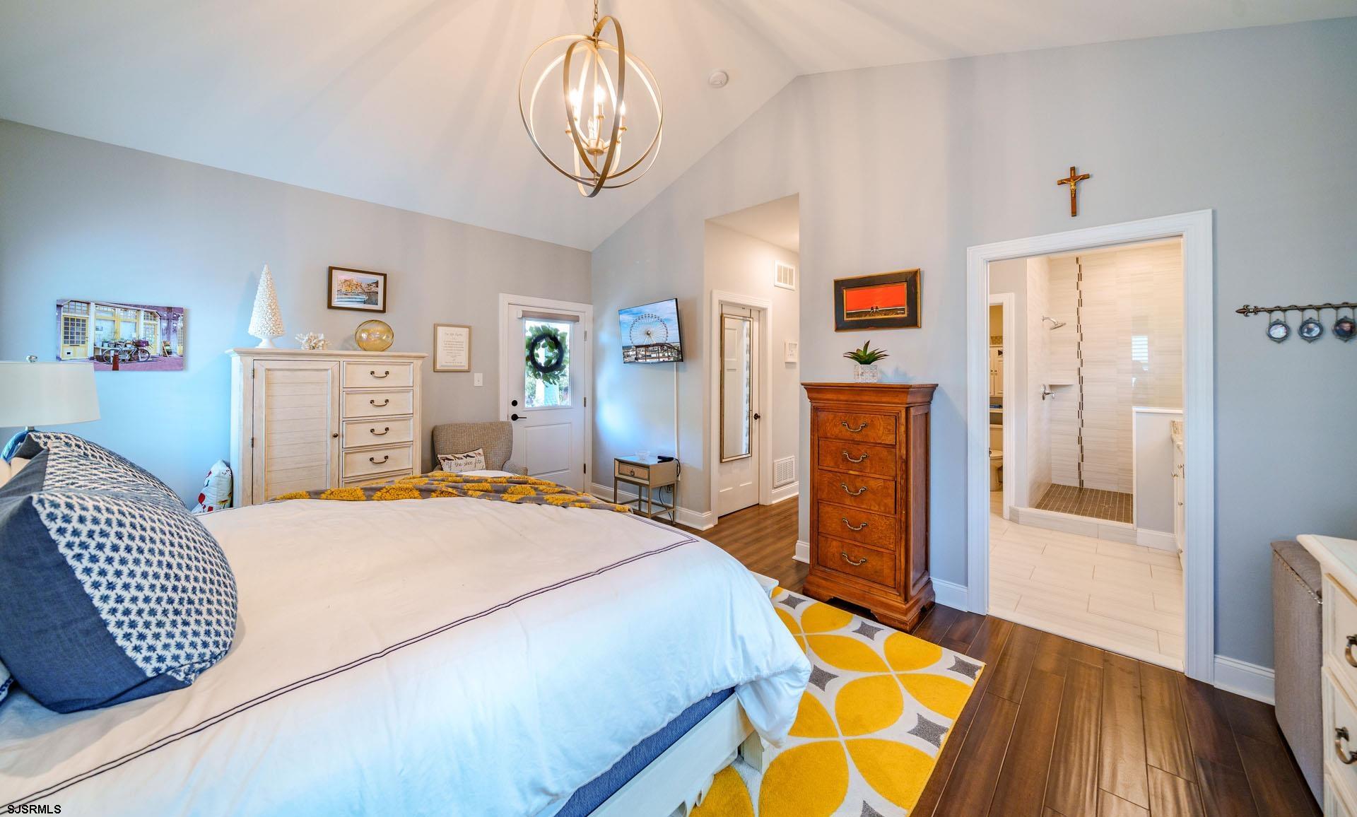 230 West Seaspray Road Ocean City, NJ 08226 - Photo 12 of 45 a bedroom with a bed and dresser with wooden floor