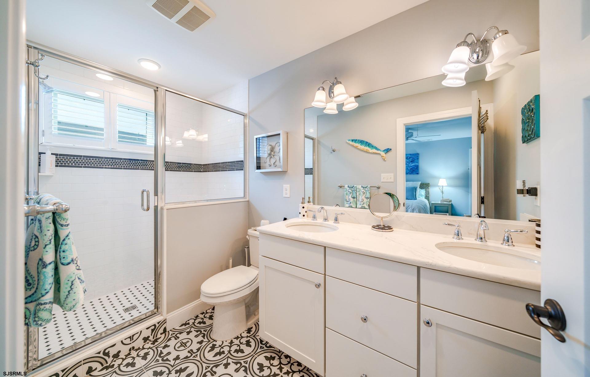 230 West Seaspray Road Ocean City, NJ 08226 - Photo 16 of 45 a bathroom with a sink a toilet and a mirror