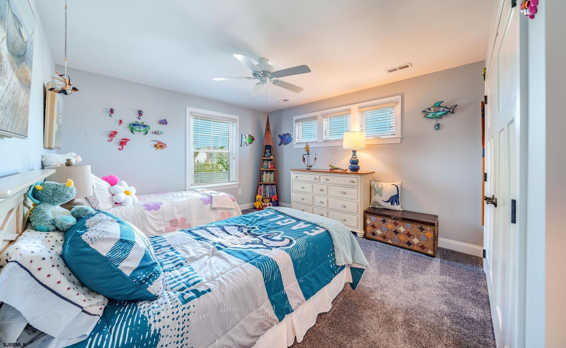 230 West Seaspray Road Ocean City, NJ 08226 - Photo 17 of 45 a bedroom with a bed and a dresser