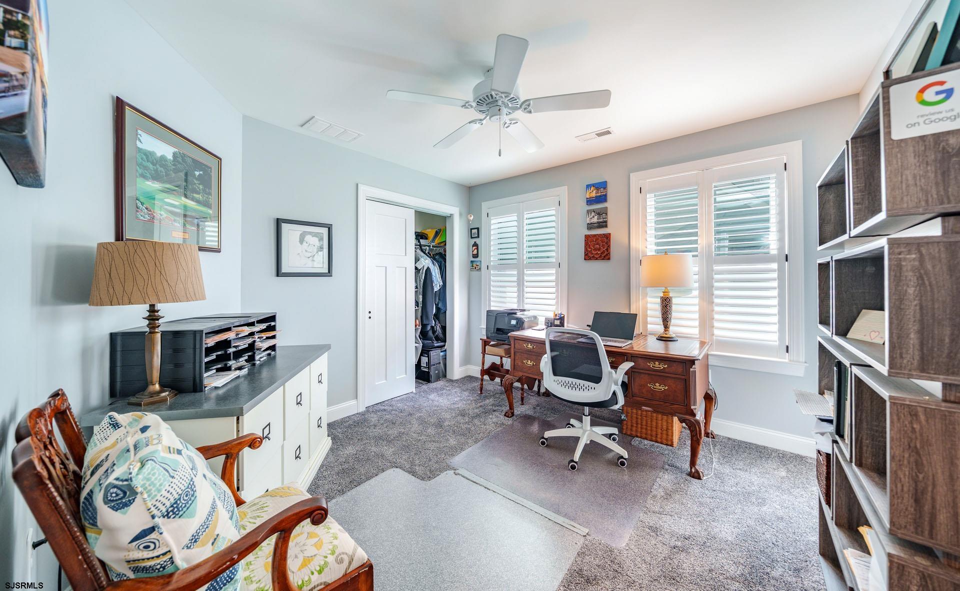 230 West Seaspray Road Ocean City, NJ 08226 - Photo 20 of 45 a living room with furniture a flat screen tv and a window