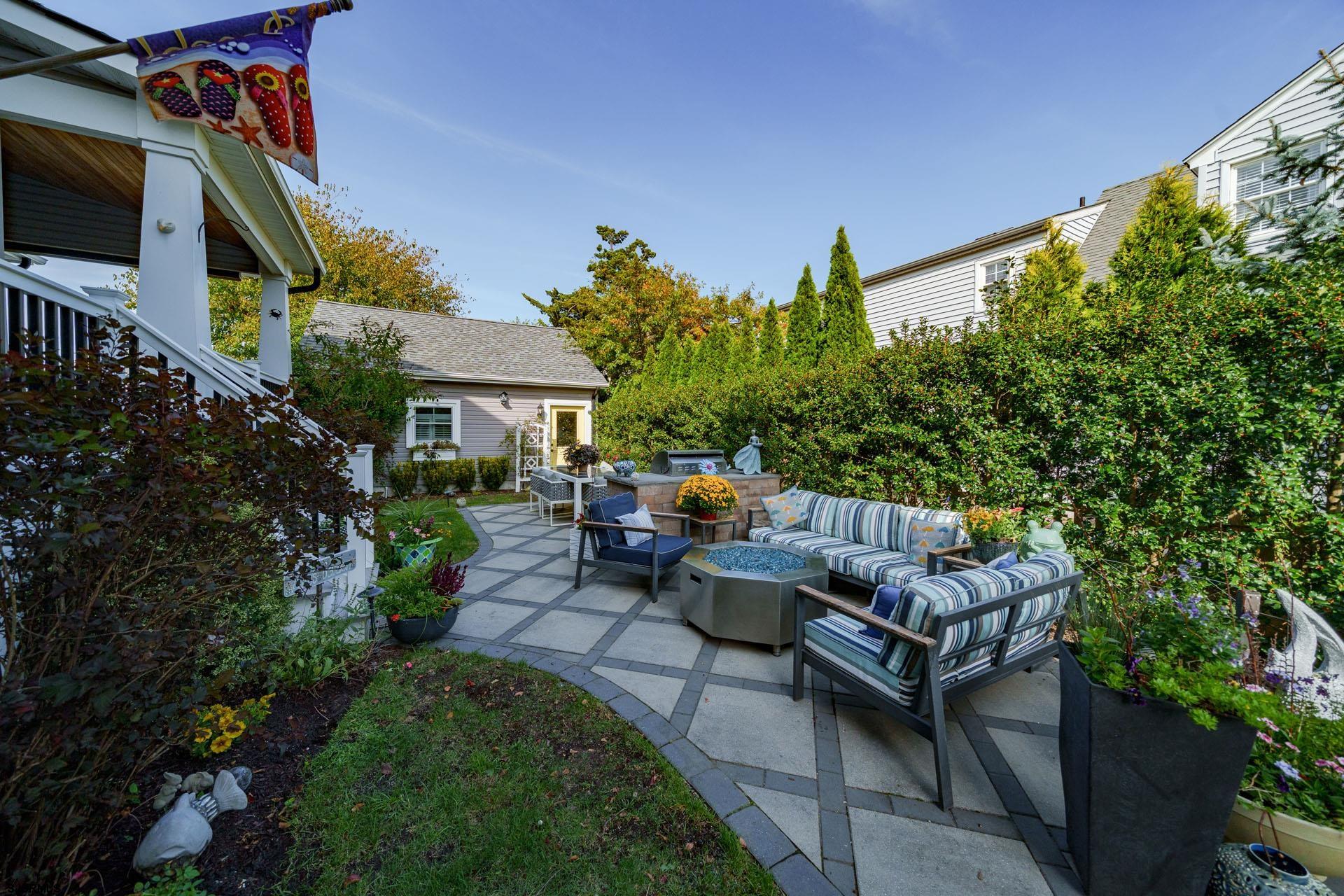 230 West Seaspray Road Ocean City, NJ 08226 - Photo 26 of 45 a view of a patio with couches and a table and chairs with wooden floor and fence