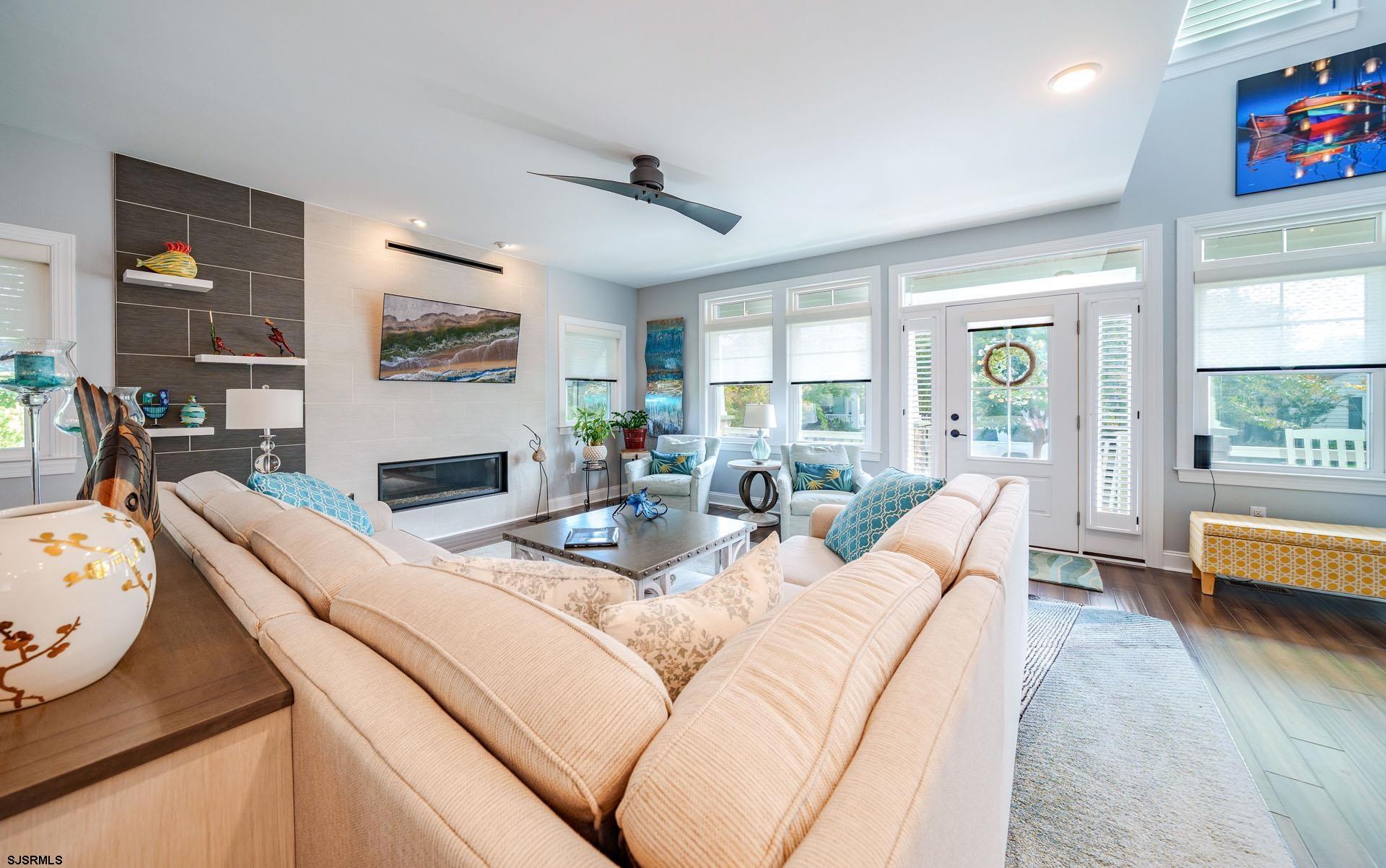 230 West Seaspray Road Ocean City, NJ 08226 - Photo 4 of 45 a living room with furniture fireplace and a large window