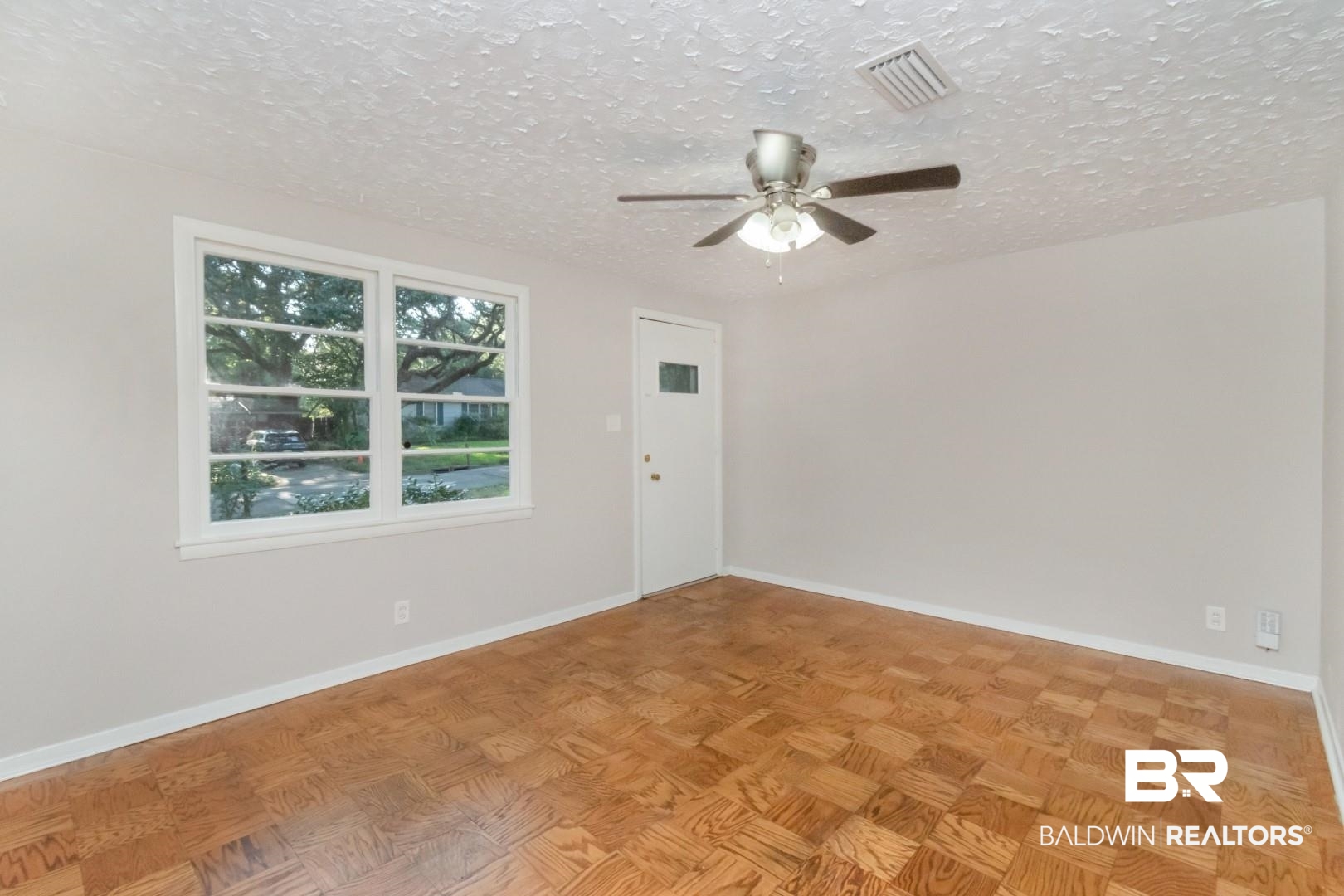 1220 Garland Drive Mobile, AL 36618 - Photo 7 of 25 Unfurnished room with light parquet flooring, a textured ceiling, and ceiling fan