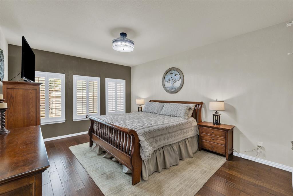 1701 Meadow Ranch Road McKinney, TX 75071 - Photo 17 of 40 a bedroom with a bed and a flat screen tv