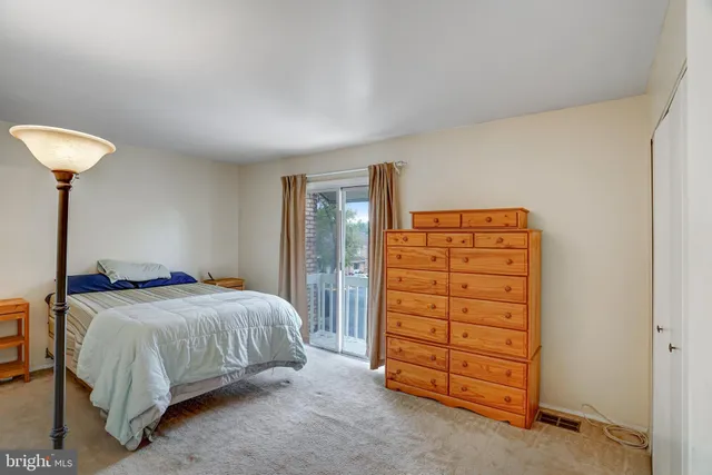 a bedroom with a bed and a chair