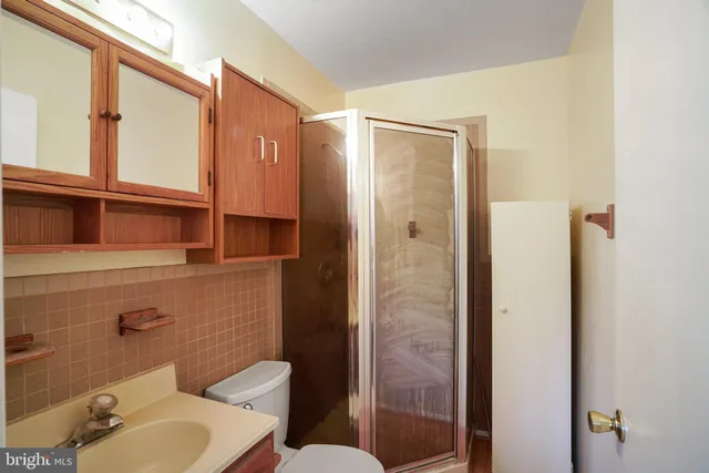 a bathroom with a toilet a sink and shower