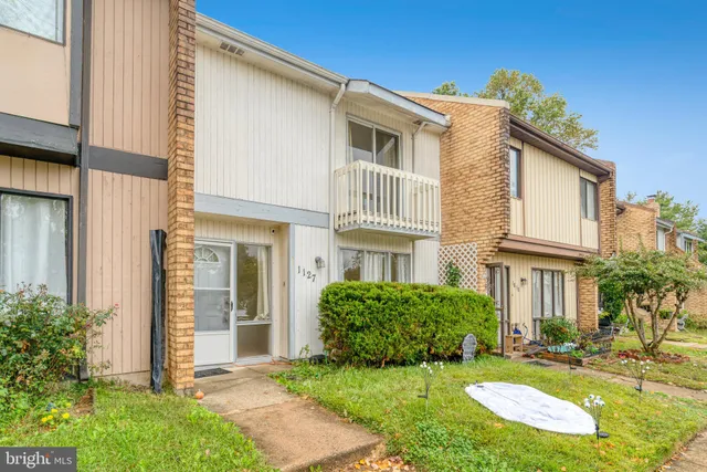 a view of a front of a house with a yard