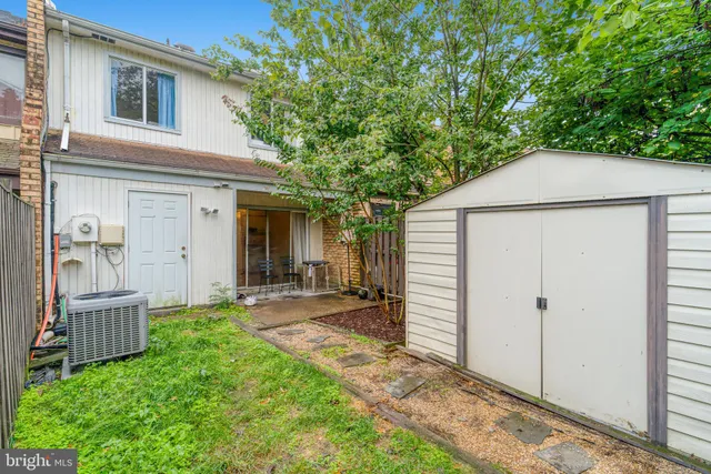 a front view of a house with a tree