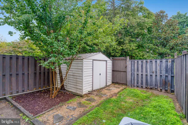 a large building with a yard and large trees