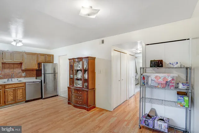 a kitchen with stainless steel appliances a refrigerator and a stove top oven