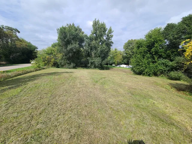 a view of a field with a building in background
