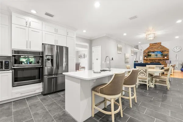 a living room with furniture and a kitchen