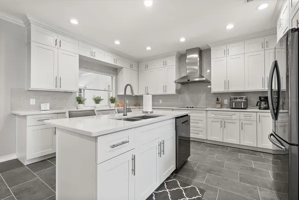 a kitchen with sink stove and cabinets